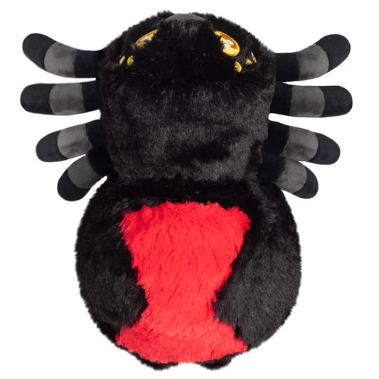 Black plush spider toy with red center and yellow eyes on a white background
