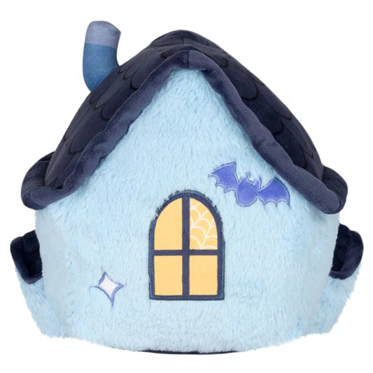 Back of a plush toy shaped like a haunted house with a bat and spider design on a white background
