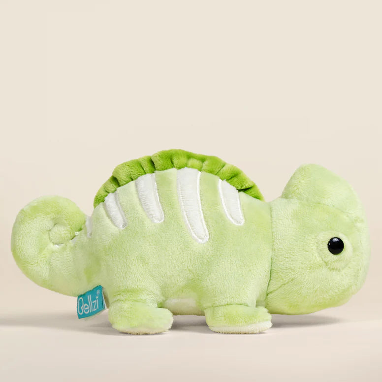 Green plush toy chameleon on a beige background.