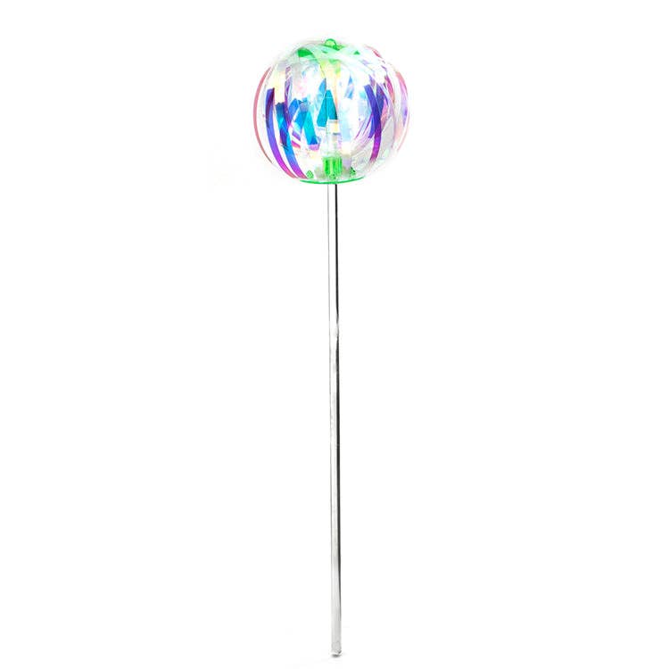 Colorful iridescent ribbon ball on a stick against a white background