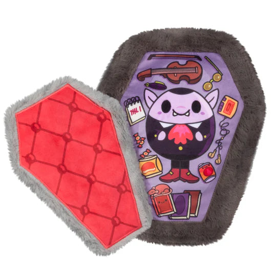 The inside of the plush coffin. The plush coffin opens to reveal a printed inside with details of a vampire with books, a violin, snacks and more.
