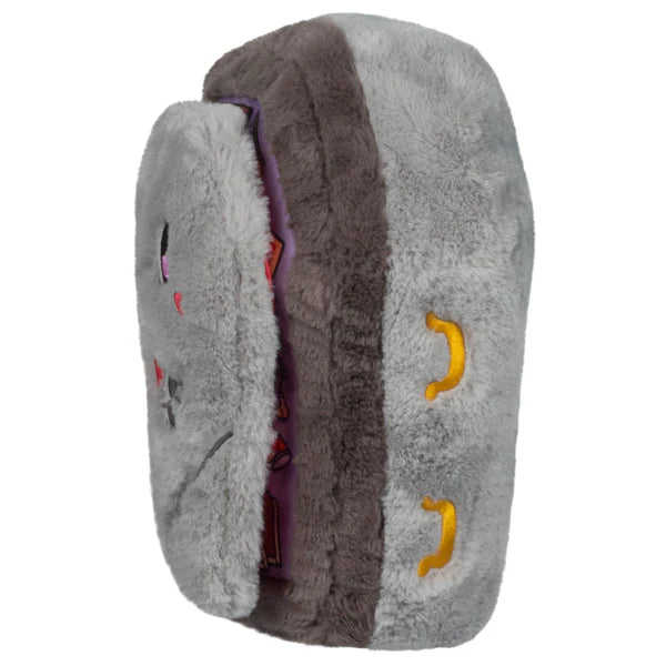 Side view of the plush coffin showing embroidered details resembling handles.