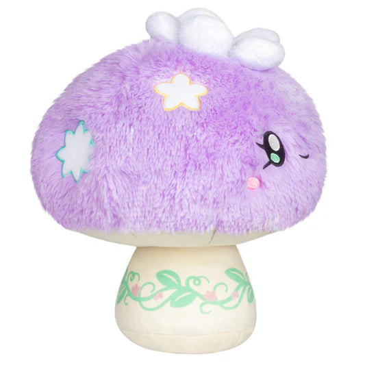 Plush toy mushroom with purple top and white base on a white background. The mushroom cap has stars embroidered on and the base has a printed leaf design.