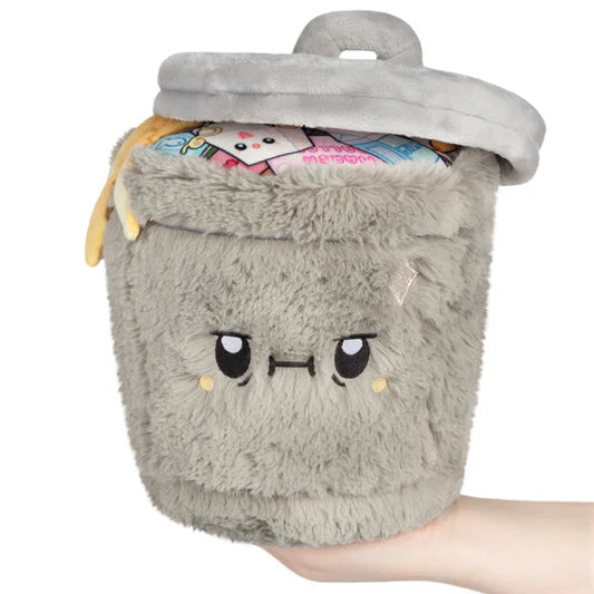 Plush toy resembling a trash can with a face on a white background